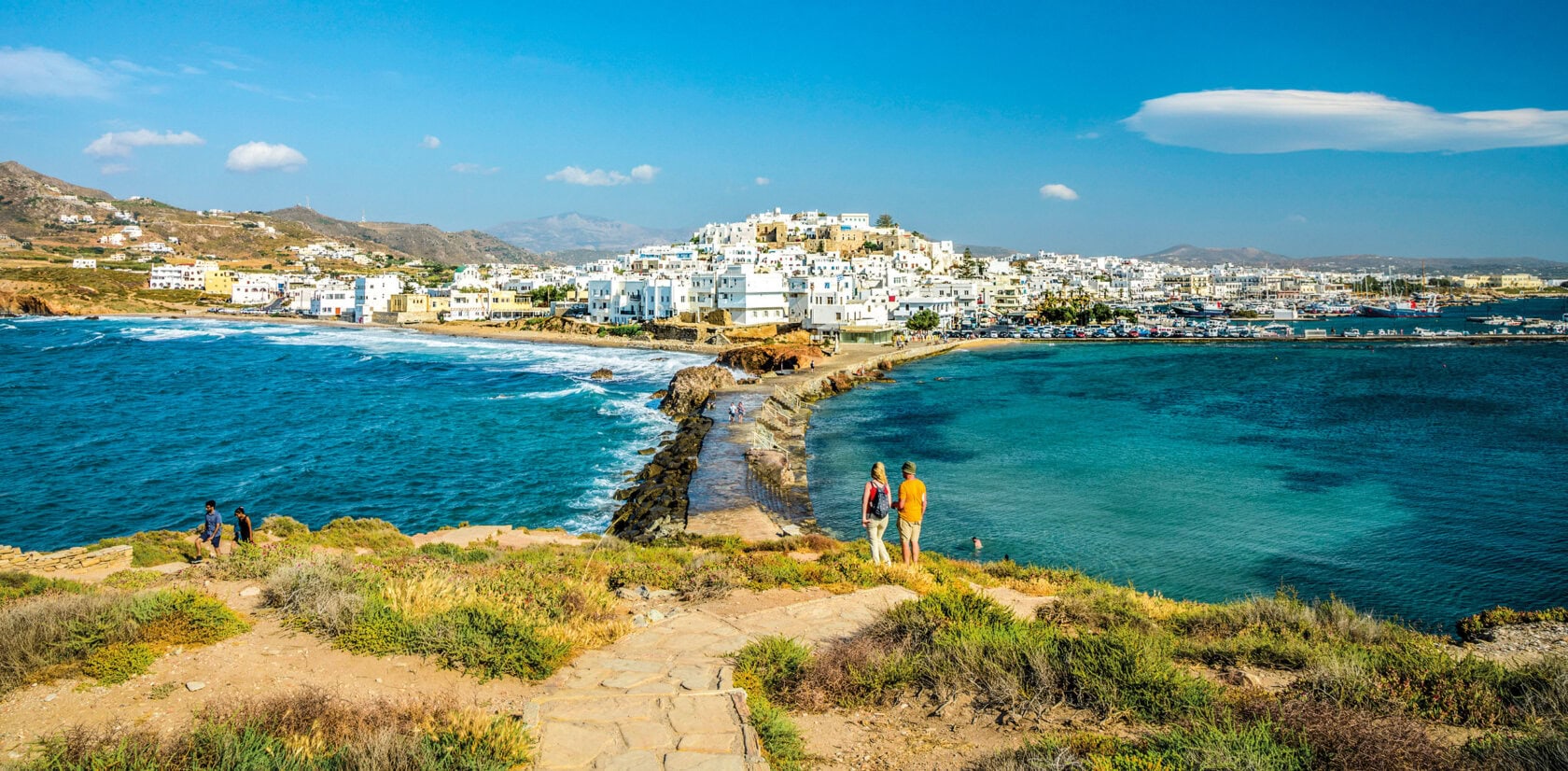 Whitewashed buildings overlooking the deep blue sea in Santorini, Greece.